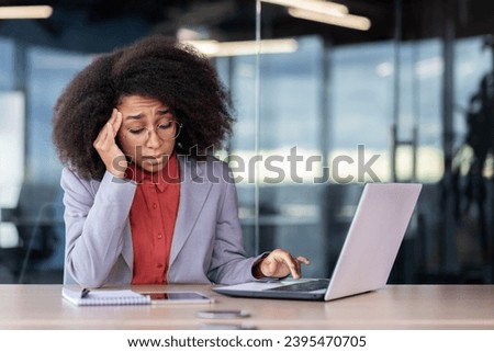 Sick woman at workplace, business woman with throbbing headache working sitting inside office with laptop. Royalty-Free Stock Photo #2395470705