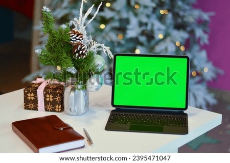 Working from cafe during Christmas holidays. A computer with a mockup green screen. Customer service. No people