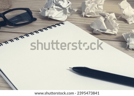 Notepad with trash paper background on office desk. Copy space.