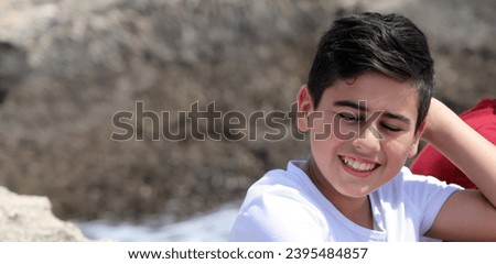 Portrait of young smiling boy With the hand on the hair.
background Photo  website and Homepage banner of smiling young boy