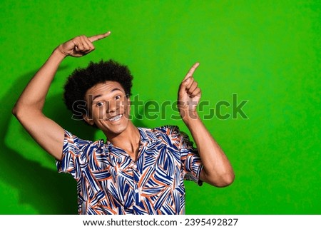 Photo of guy promoting hotel summer holidays alcohol pub with no limits drinks point fingers novelty isolated on green color background