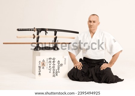 Portrait of aikido sensei master with black sensei belt in taekwondo kimono on black background. Traditional samurai hakama kimono. Healthy lifestyle and sports concept. Royalty-Free Stock Photo #2395494925