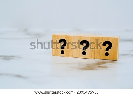 A wooden block with a question mark sign on it