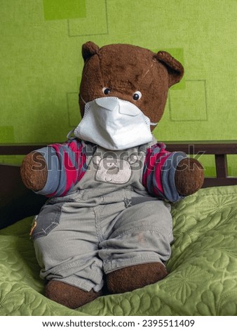picture with old teddy bear, face mask, call for protection