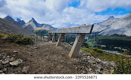 Rugged Canadian Rockies with wooden guide rail Royalty-Free Stock Photo #2395526871