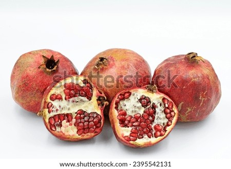 Pomes of pomegranates (Punica granatum) in the autumn Royalty-Free Stock Photo #2395542131