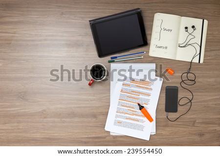 Exam week background, with various study tems, such as a highlighted reader with standard (lorum ipsum) text, a cup of coffee, electronic tablets, music player and ear plugs, and a calendar
