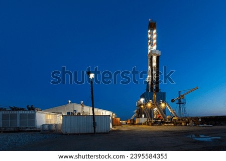 Drilling rig in oil field for drilled into subsurface Royalty-Free Stock Photo #2395584355
