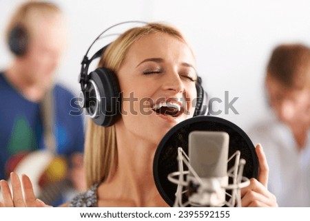 Music, voice and woman with microphone, headphones and band performance with singing talent. Recording studio, art and girl musician live streaming song for record label, sound and happy audio singer