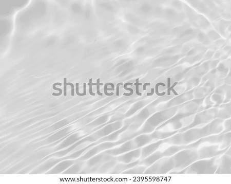 Closeup​ blur​ abstract​ of​ surface​ blue​ water. Abstract​ of​ surface​ blue​ water​ reflected​ with​ sunlight​ for​ background.Top​ view​ of blue​ water.​ Water​ splashed​ abstract​ background.