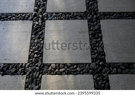 abstract patio design with black gravel and stone pavers