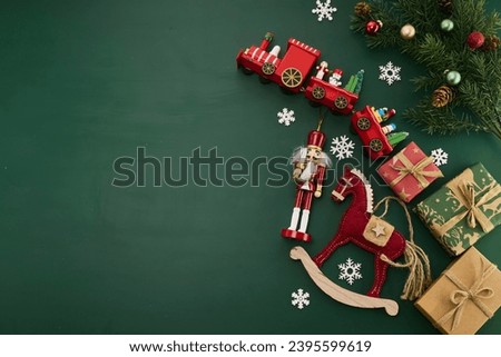 Christmas border flat lay with presents, Christmas toys on green background.