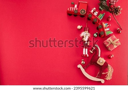 Christmas border flat lay with presents, Christmas toys on red background.