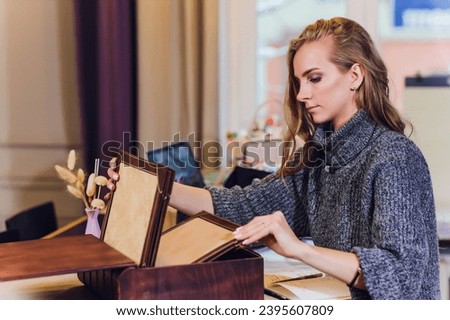 Portrait of smiling female interior designer sitting at office desk