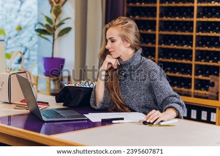 Portrait of smiling female interior designer sitting at office desk