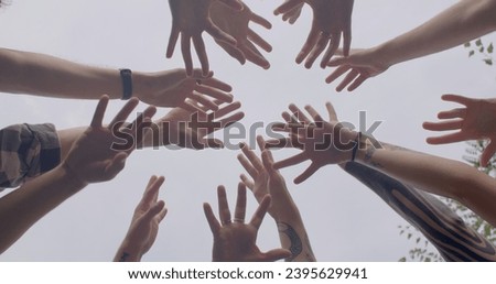 strong sense of teamwork, camaraderie, shared commitment to success. People lifestyle Team members come together by holding hands working closely together to achieve common goal.  Royalty-Free Stock Photo #2395629941