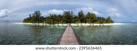 Small Tropical Island Panorama with Wooden Pier or Jetty leading to the tropical Paradise Beach - Republic of Maldives