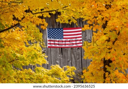 American flag on a barn in fall color.