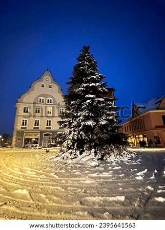 The atmosphere of the city and houses in winter, snow falls and covers the roads and buildings