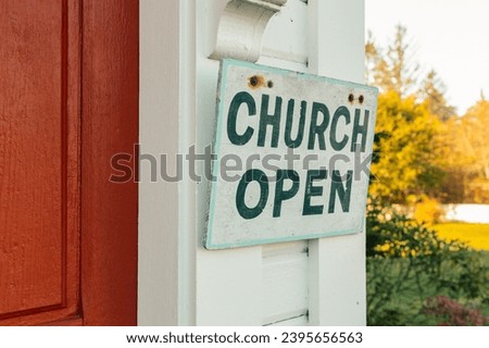 Church open sign on entrance of small town church