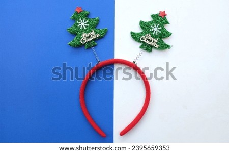 decorated Beautiful headband funny christmas trees isolate on a blue and white backdrop.
concept of joyful Christmas party,New year is coming soon, festive season decoration with Christmas elements