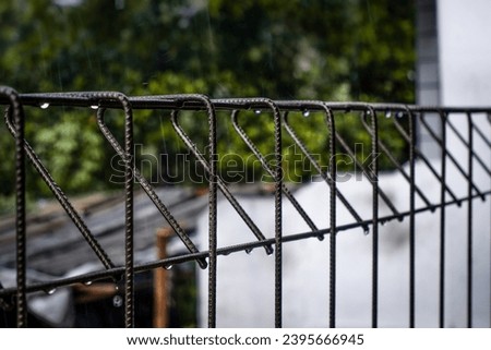 water droplets dripping from a fence wet by rain