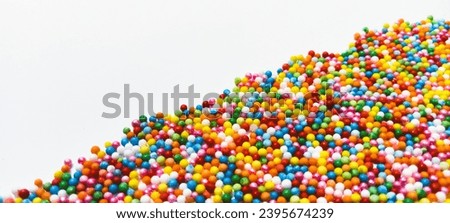 Rainbow sugar grains isolated on a white background 