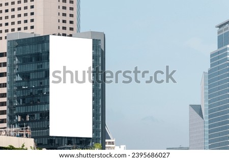 Mock up white large LED display vertical billboard on tower building .clipping path for mockup Royalty-Free Stock Photo #2395686027