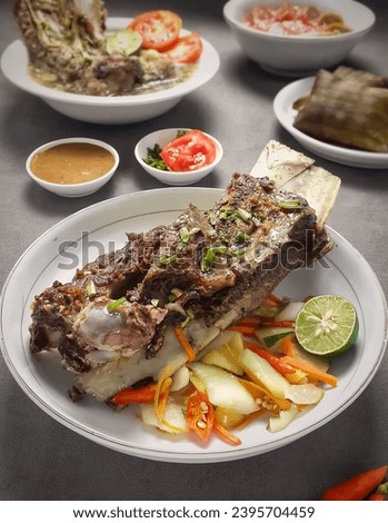 Variations of typical Makassar food that are rich in spices include konro soup, grilled ribs, buras and green banana ice Royalty-Free Stock Photo #2395704459