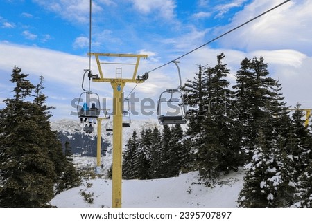Ski Lift snowy mountain winter forest with chair lift At The Ski Resort in winter. Snowy weather Ski holidays Winter sport and outdoor activities Outdoor tourism, Bursa (Turkey), Uludağ ski lift Royalty-Free Stock Photo #2395707897