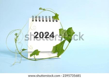 Year 2024 business sustainability goal and sustainable development target concept. Calendar with ecological environment icons and green plant.