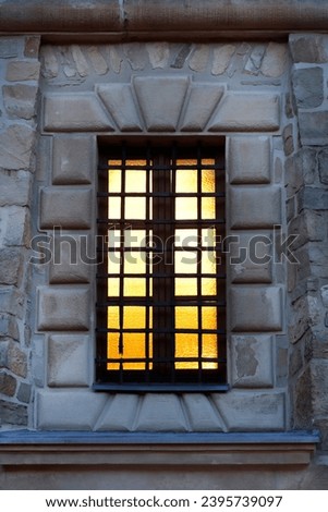 Old window on the facade of a historic monastery. Royalty-Free Stock Photo #2395739097