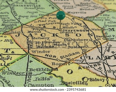 Jackson County, Georgia marked by a green tack on a colorful vintage map. The county seat is located in the city of Jefferson, GA.