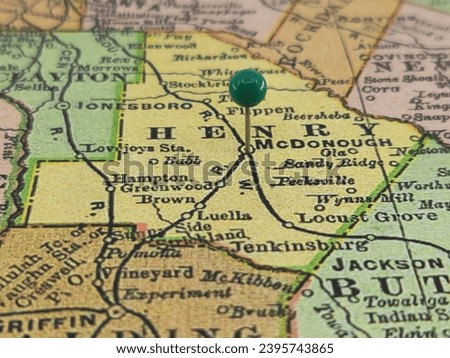 Henry County, Georgia marked by a green tack on a colorful vintage map. The county seat is located in the city of McDonough, GA. Royalty-Free Stock Photo #2395743865
