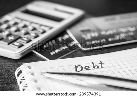 Debt payments, the calculation of the balance, a credit cards and a calculator on the table
