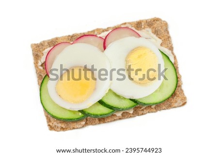 Whole Grain Crispbread with Fresh Cucumber, Egg, Cream Cheese and Radish - Isolated on White. Quick and Healthy Sandwiches. Crispbread with Tasty Filling. Healthy Dietary Snack - Isolation Royalty-Free Stock Photo #2395744923