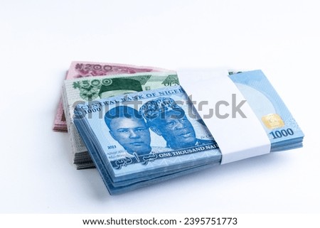 Wads, bundle of Nigerian Naira notes on a white background Royalty-Free Stock Photo #2395751773