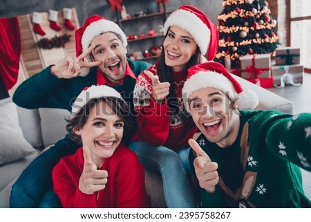 Photo of funky peaceful buddies make selfie point fingers camera you show v-sign christmas atmosphere house indoors