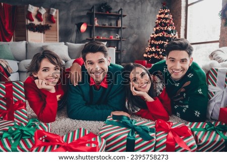 Full length photo of friendly peaceful people lying carpet floor cuddle tree garland christmas time giftbox apartment indoors