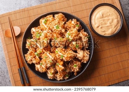 Bang Bang Chicken succulent chicken chunks ensconced in a delectable batter, crisped up with Panko, and draped in sauce closeup on the plate on the table. Horizontal top view from above
 Royalty-Free Stock Photo #2395768079