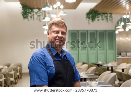 Portrait of male waiter blond 40-44 years old, close-up. Royalty-Free Stock Photo #2395770873