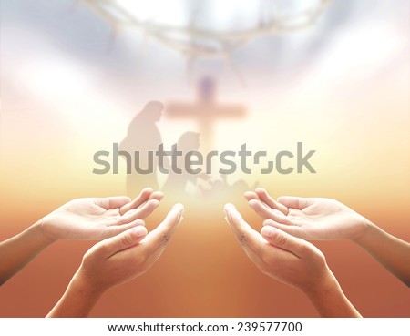Nativity Christmas concept: Hands of men praying over blurred the cross