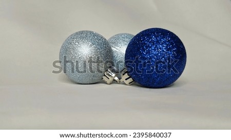 Silver and blue with glitter Christmas balls on a white background
