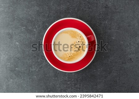 Red white cup of fresh hot espresso coffee  top view on dark grey concrete background. Coffee break concept. Royalty-Free Stock Photo #2395842471