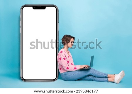 Full size body photo of satisfied young it specialist student girl first program create website for phone isolated on blue color background