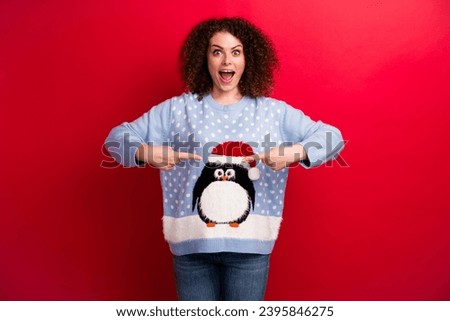 Photo of amazed young student girl point fingers herself scream pointing herself in xmas penguin sweater isolated on red color background