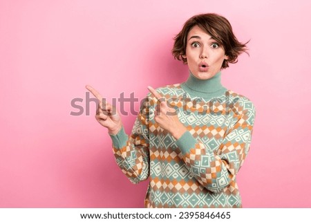 Photo of impressed pretty girl pouted lips indicate fingers empty space ad proposition isolated on pink color background