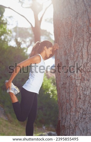 Woman, feet and stretching by tree for fitness, workout or runner with training sport in nature or forest. Young athlete or tired person stop with legs, muscle or balance in woods for exercise