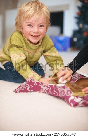 Portrait, boy and opening christmas presents for holiday, happy and excited for gift. Celebration, smile and family home with decorations, tradition and joy for santa claus or childhood memories