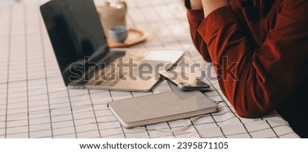 Cropped photo of Freelancer business Asian woman holding coffee cup and at doing planning analyzing the financial report, business plan investment, finance analysis the workplace.